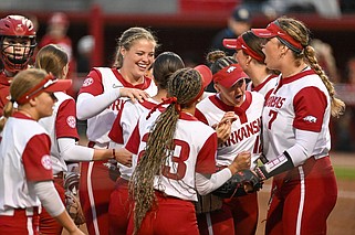 Members of the Arkansas softball team celebrate Friday after turning an inning-ending double play in the seventh inning of the No. 16 Razorbacks’ 1-0, 9-inning victory over the No. 14 Alabama Crimson Tide at Bogle Park in Fayetteville. Lauren Camenzind won the game with an RBI single in the bottom of the ninth inning. More photos at nwaonline.com/420alaua/.
(NWA Democrat-Gazette/Caleb Grieger)